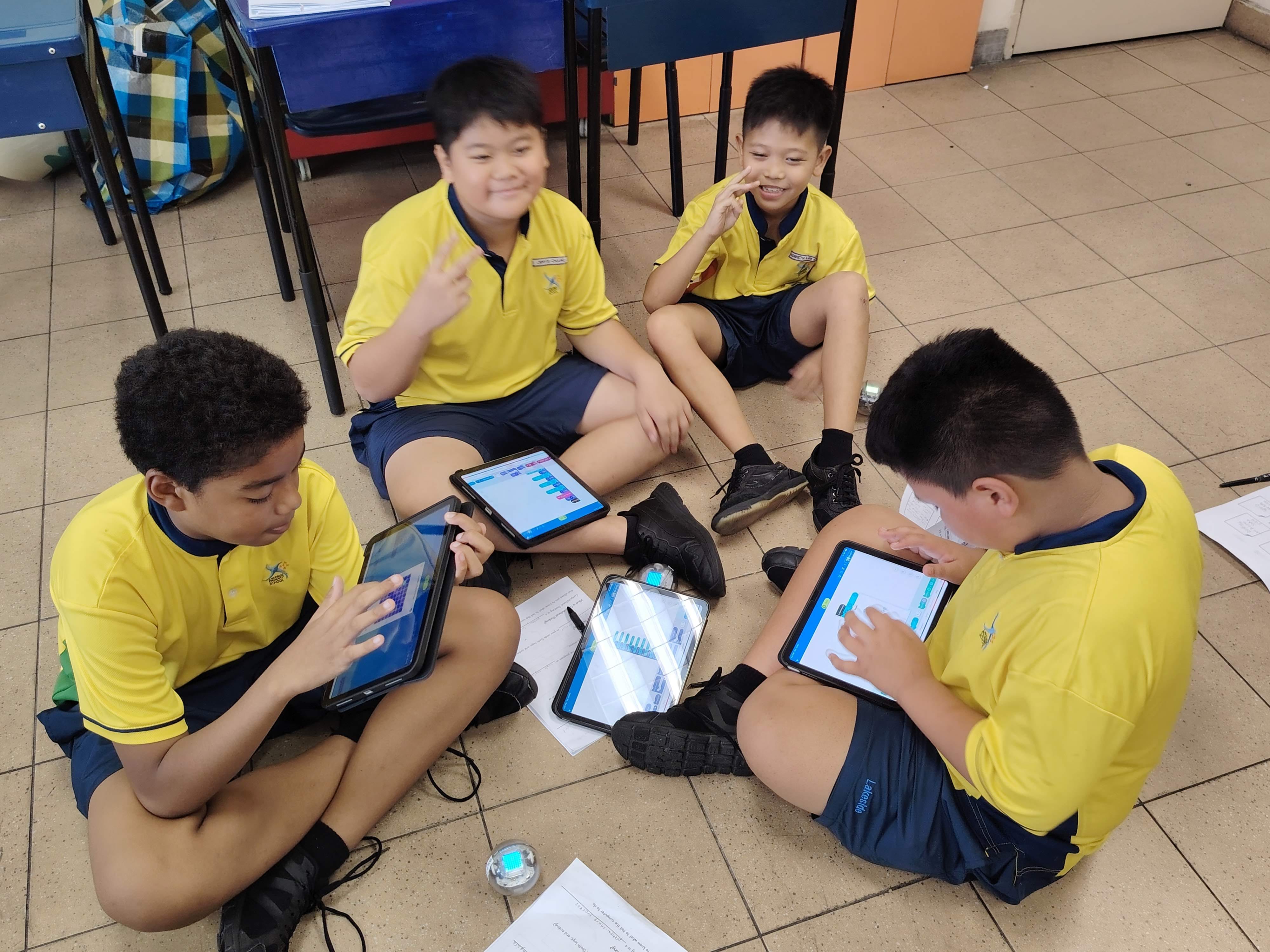 Students sit around in groups for group discussions